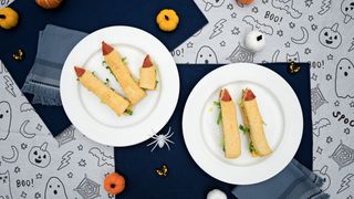 Halloween-themed finger sandwiches made to look like witches' fingers with painted nails