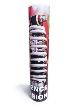 The back half of a mailing tube with the words 'Experience Suspension' on the bottom over a photo of a lawn mower's suspension spring.